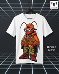 A white short-sleeve t-shirt hanging on a black hanger against a dark grid background. The shirt features a cartoon graphic of a cockroach dressed in an orange hoodie, sunglasses, and cargo pants with the text 'PROUD COCKROACH'.